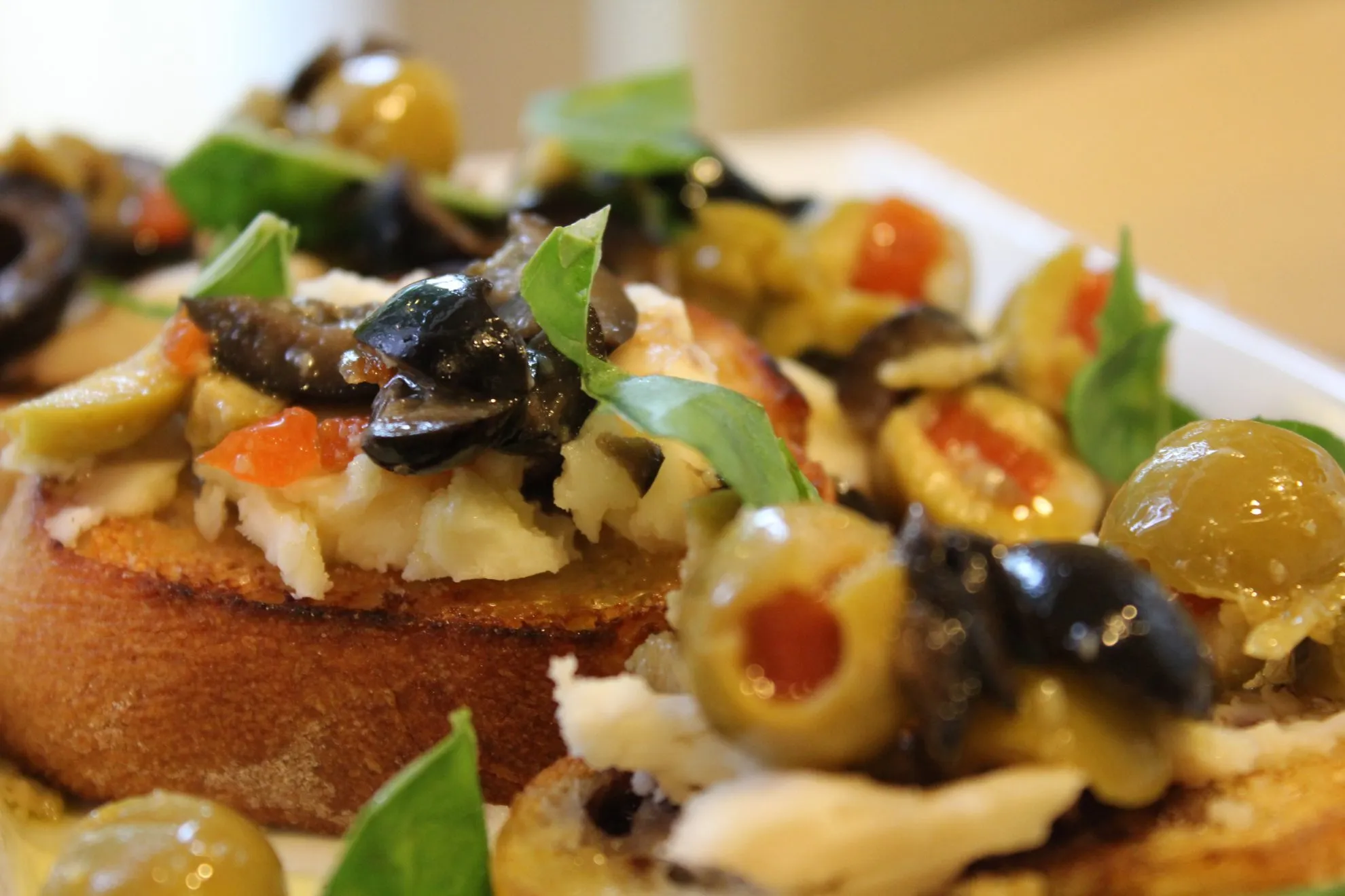 Green Olive Goat Cheese Basil Crostini
