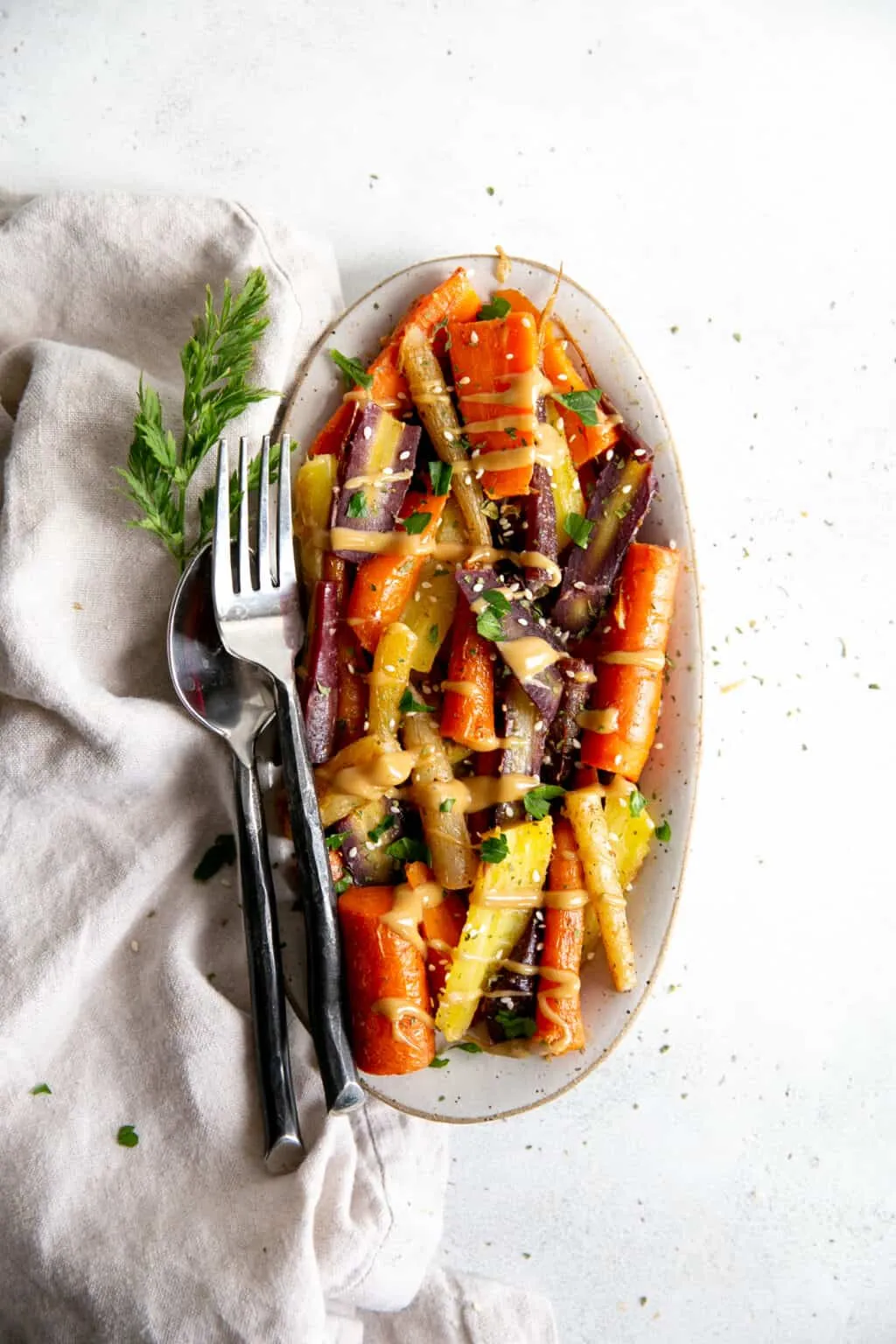 Whole Roasted Rainbow Carrots with Creamy Hummus and Green Tahini Sauce